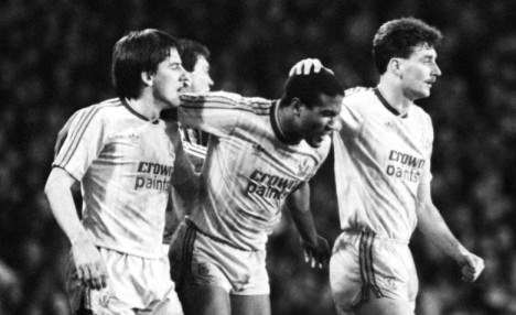 Liverpool's John Barnes (c) celebrates scoring his team's second goal with teammates Peter Beardsley (l) and John Aldridge (r)